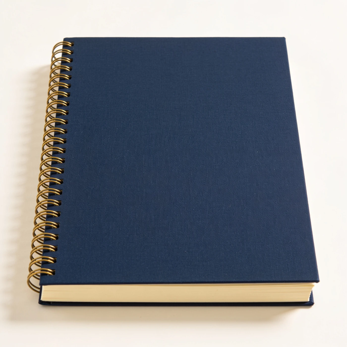 Field Spiral Notebook — navy rigid board covers; brass-tone wire spiral; lined paper